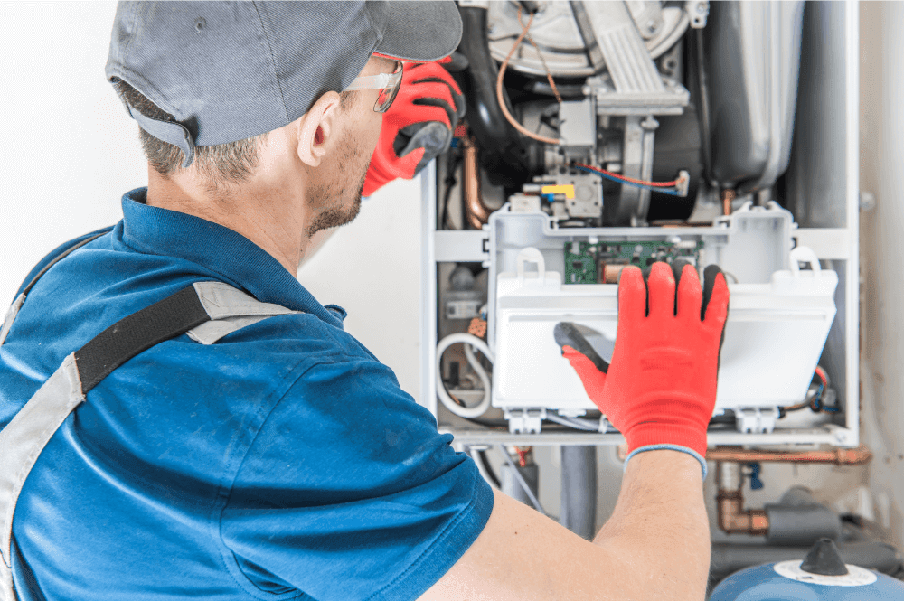 A Team HVAC Tech working on a Furnace